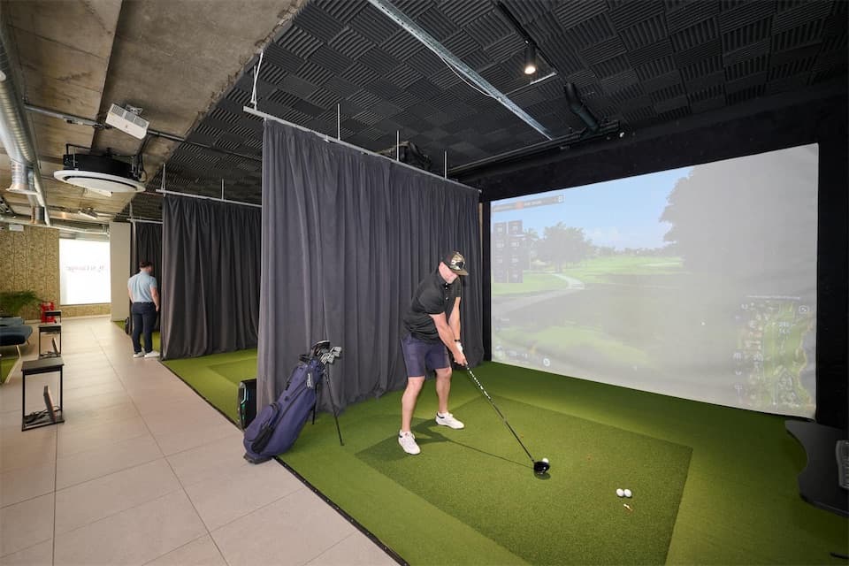 A player in a simulator bay at Caddi Club Chelsea
