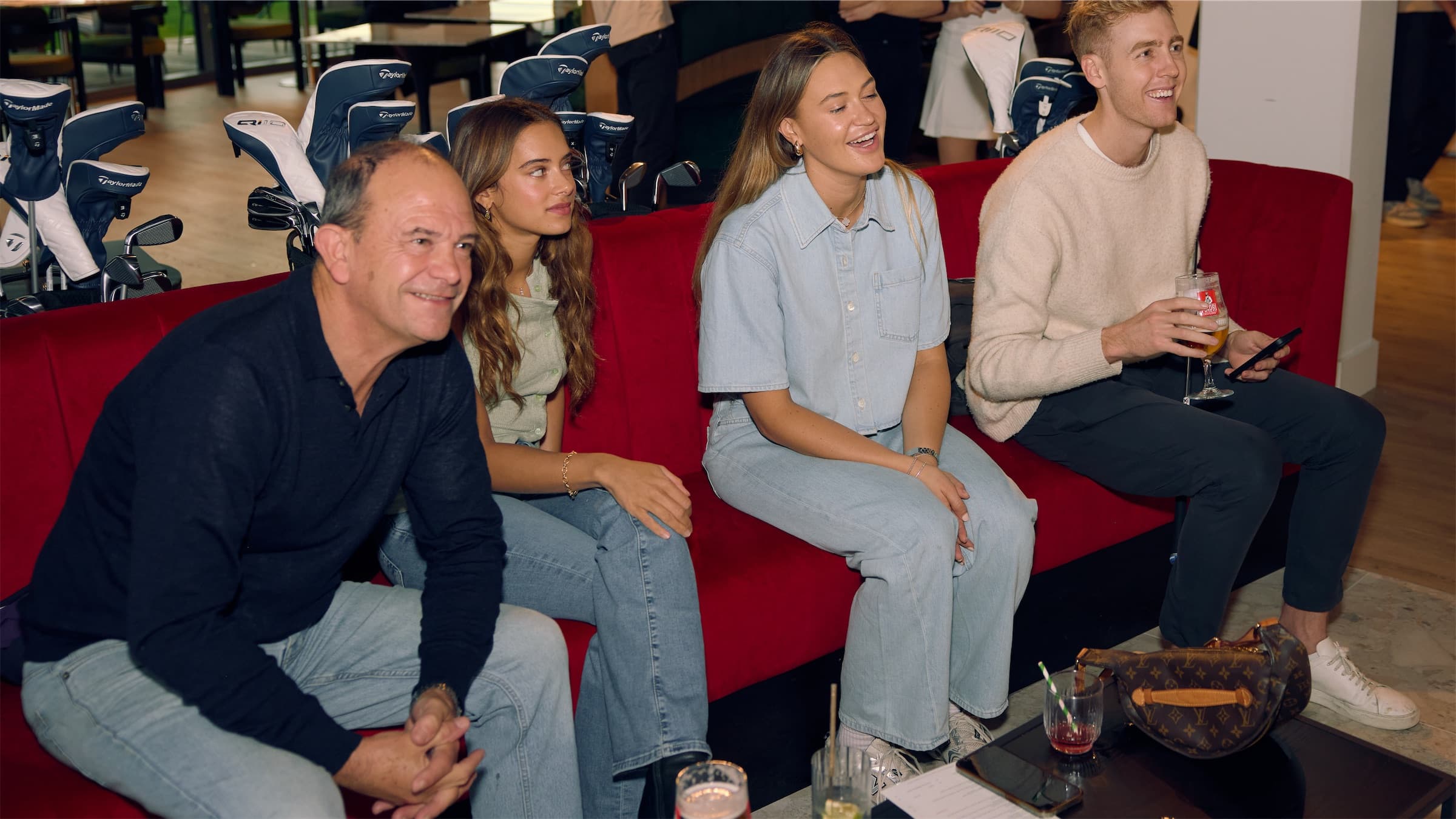 Four friends laughing together at Caddi Club