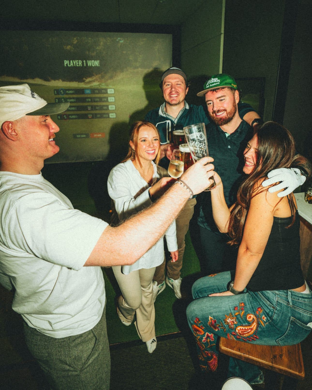 A group raising their drinks together at a Caddi Club team night